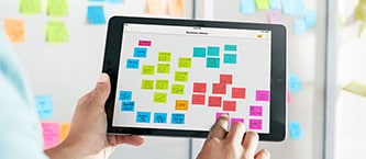 Tablette affichant un tableau de tâches numérisé de notes Post-it®
